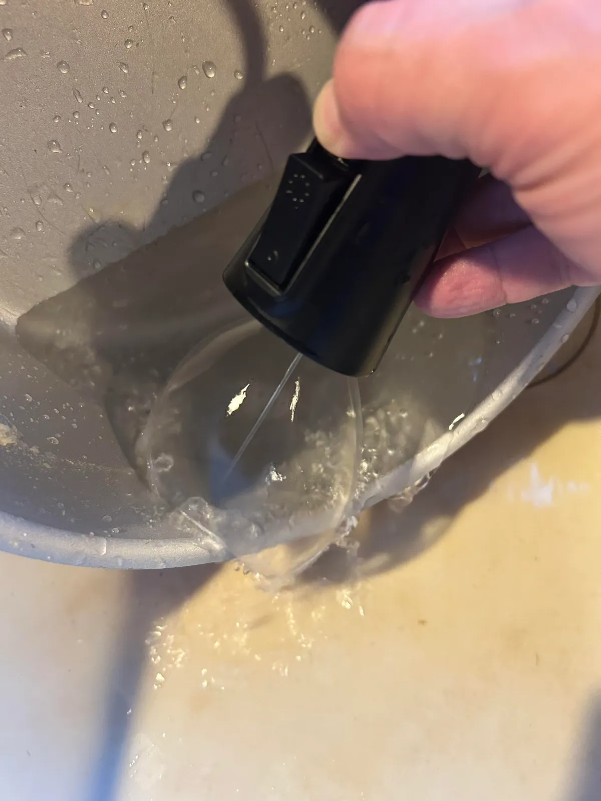 My sink sprayer has a tough spot remover. It shoots a high pressure stream down the middle that is surprisingly powerful, but a cone of water around it that blocks all the splashes