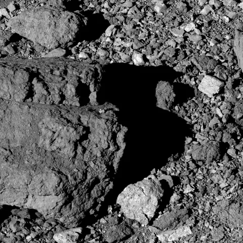 Surface of asteroid Bennu (with NASA's astronaut Buzz Aldrin for scale)