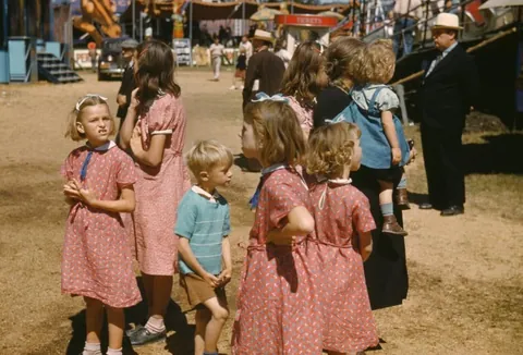 Family during the depression with girls in flour sack dresses. Circa 1930s.