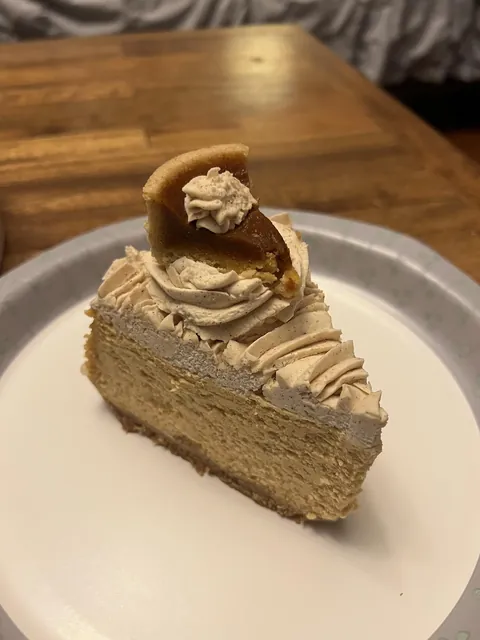 This cheesecake I got has a tiny slice of pie on it.