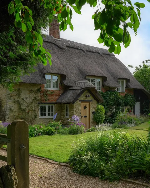 Thatched roof cottage in the small village of Little Haseley, Oxfordshire, England.