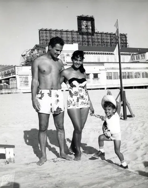 Family smile at Atlantic city, New Jersey beach, 1950s. At the time the beach was segregated,