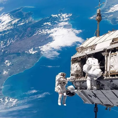 Astronauts working outside the International Space Station (ISS) in 2006. New Zealand behind them!