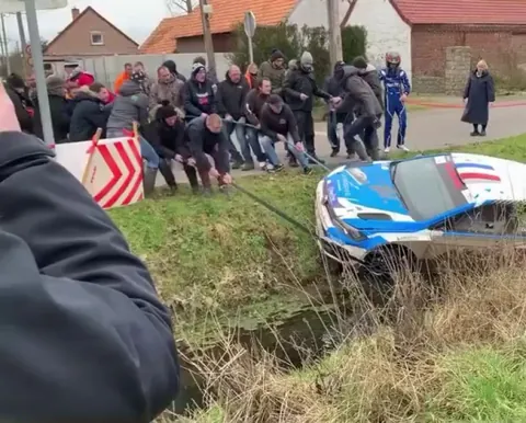 Helping out a rally car driver