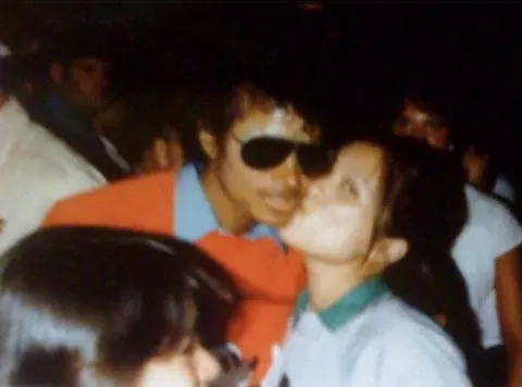 My mom kissing Michael Jackson on the cheek circa early 80s