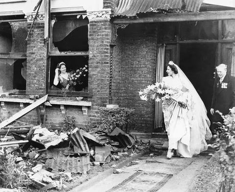 Bride leaving her recently bombed home to get married, London, Nov 4 1940