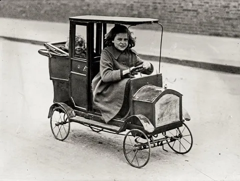 Child in her pedal car, ca. 1922. 