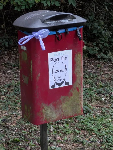 Our Poo Tins: a local satirist has either vandalised or significantly improved our local dog poo bins.