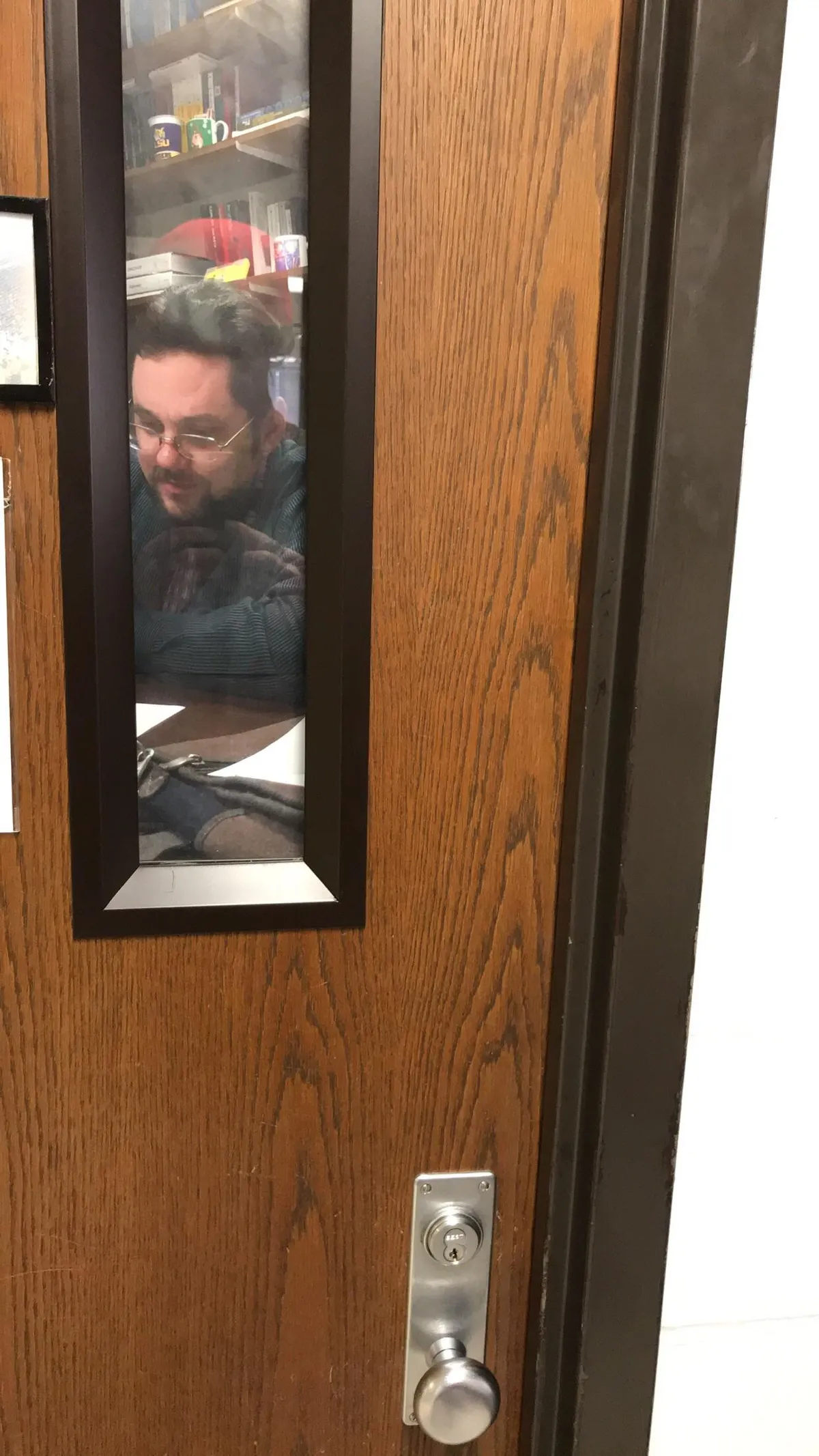 My teacher put up a picture of himself on his door so it looks like he’s in his office.
