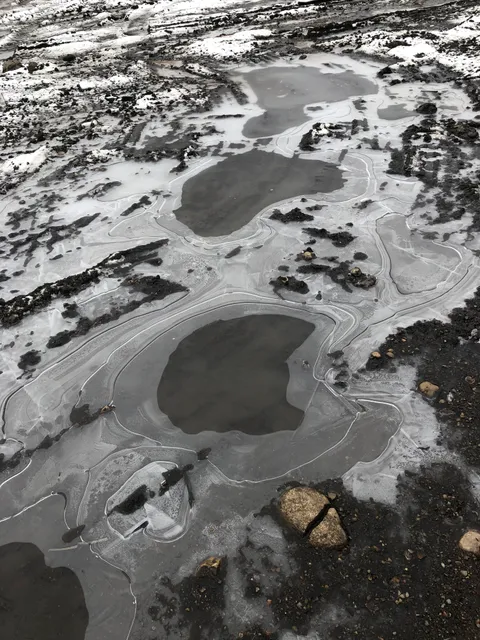The way this picture of a frozen puddle in my backyard looks like a landscape from the perspective of a plane.