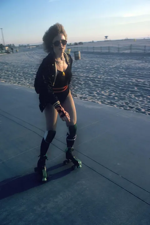 Venice Beach California during the late 1970s roller skate craze. Still has some 70s vibe but you can feel the 80s coming.