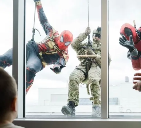 Tactical team personnel dressed up as Spiderman and Deadpool rappel down the walls of the Montreal Children's Hospital