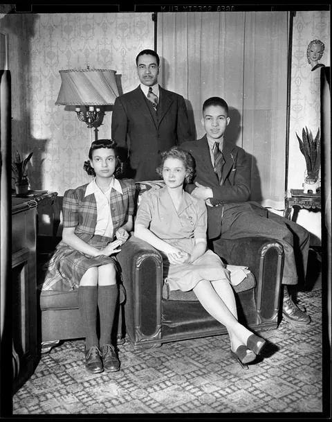 Mixed family posing for their photo Pittsburgh, circa 1940s, Agfa safety film.