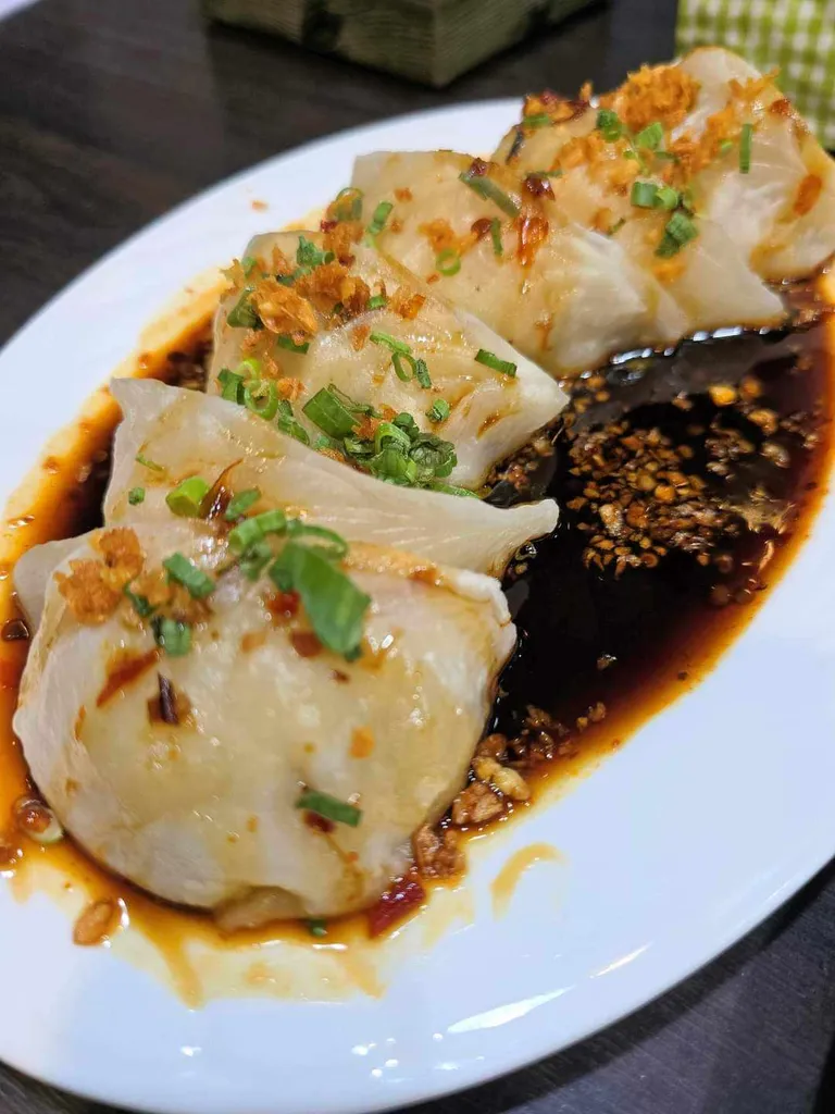 [i ate] Spicy pork dumplings with a sweet spicy sauce and plenty of fried garlic 