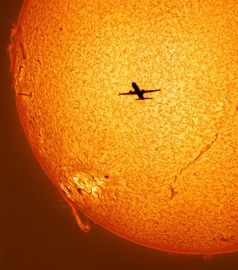 I Captured a Plane Transiting the Sun Yesterday at the Same Time as a Powerful Eruption Happened on the Limb.