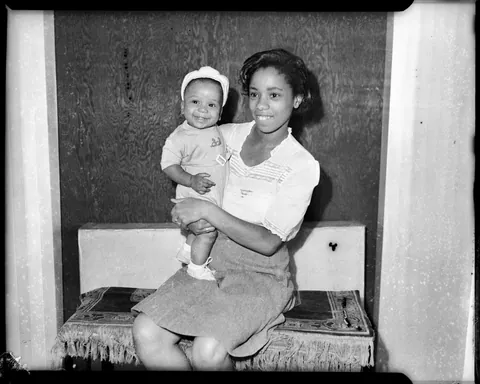 Young mother poses with her smiling boy, circa 1940s. Agfa safety film.