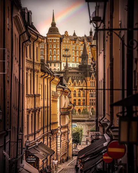 19th-century Neo-Gothic Mariahissen, once housing a now-defunct lift, and the 19th-century Dutch Renaissance Laurinska huset residential building on the edge of Södermalm Island, seen across the bay from a street in Gamla Stan, the historic old town of Stockholm, Sweden.