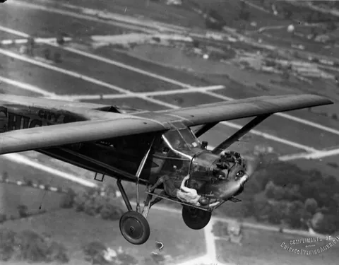 One of the Hunter brothers checks the engine of their plane while in flight. This was during their record 23 day non stop flight: 11 of June 1930 to 4 of July 1930. Source in comment