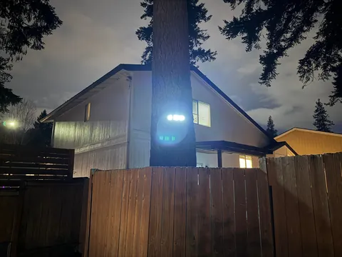 Neighbor installed a motion sensing LED light on a tree and aimed directly into my yard