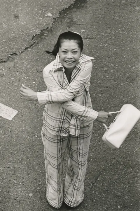 In 1974, Masahisa Fukase photographed his wife, Yōko Wanibe, every morning from the window of their apartment in Tokyo as she left for work.