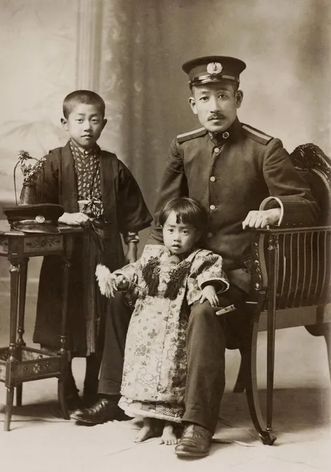 A naval warrant officer and his children. Japan, 1910