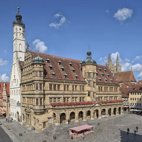 The part Gothic (white tower) and part Renaissance (yellow sandstone building) town hall of Rothenburg ob der Tauber, Germany.