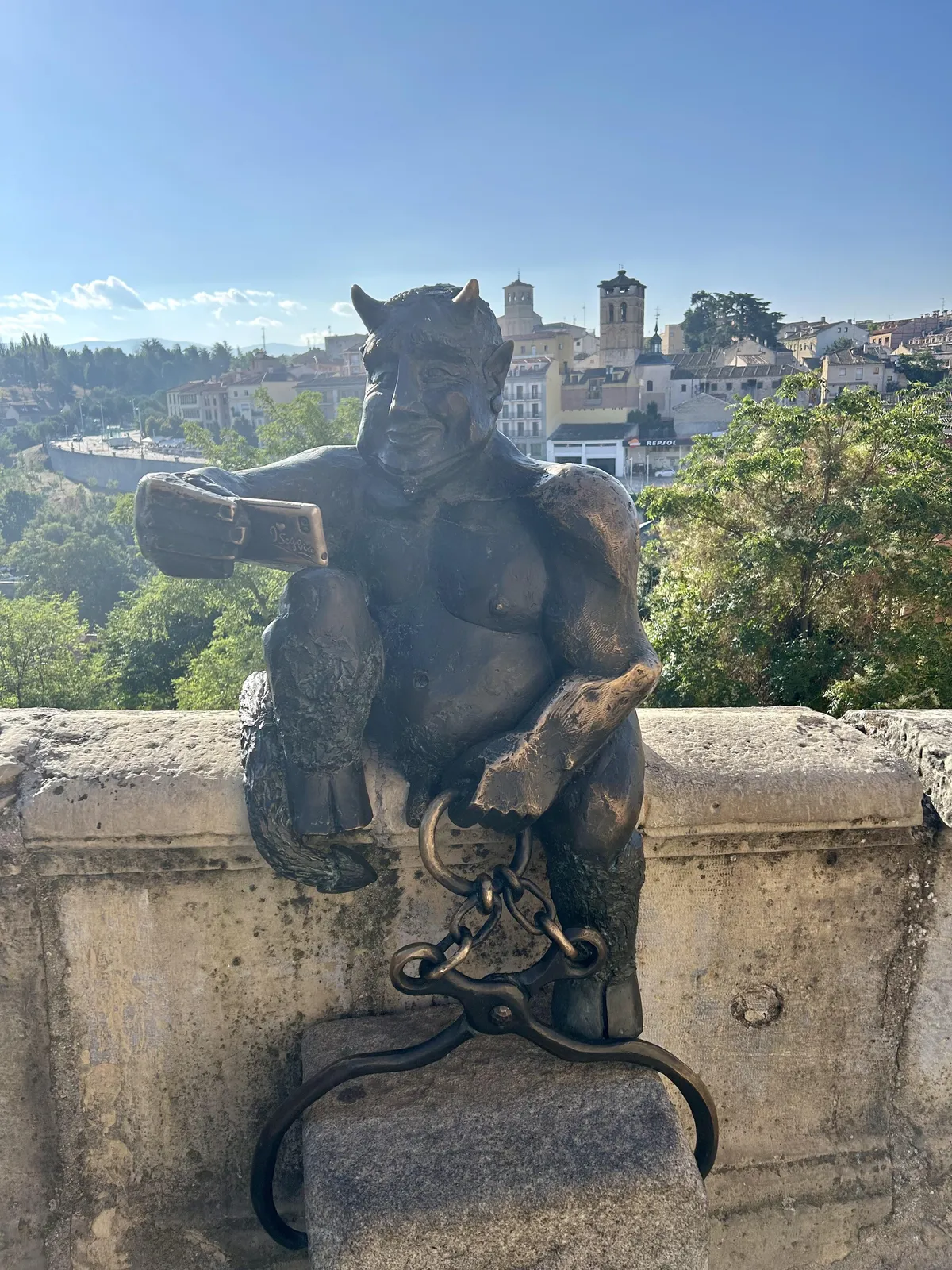 In the city of Segovia (Spain) there is the statue of a devil taking a selfie...