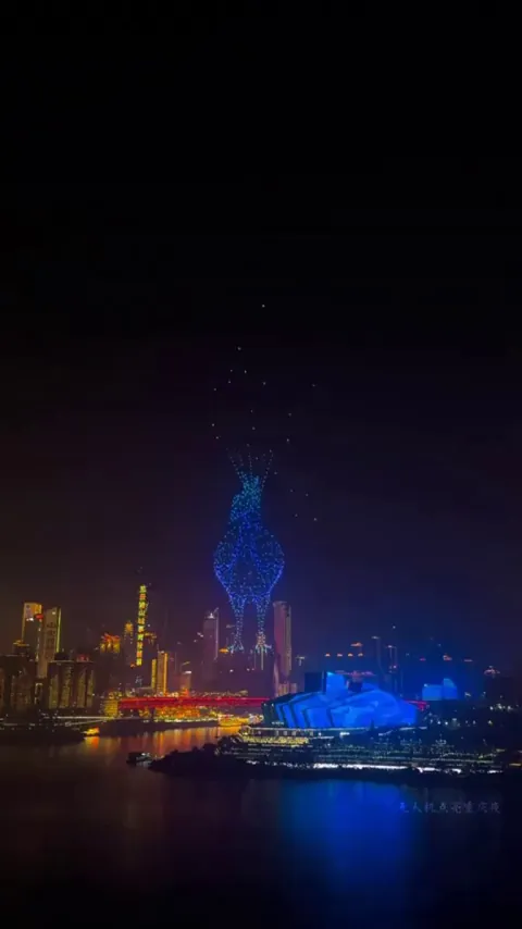 A stunning drone animation blending a peacock and a dancer in the Chongqing night sky