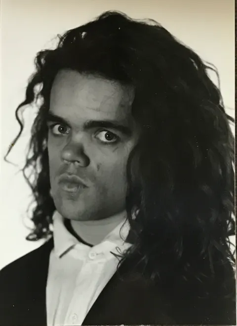 You all saw the high school mullet photo, now see how he grew it out: Peter Dinklage in college, late '80s