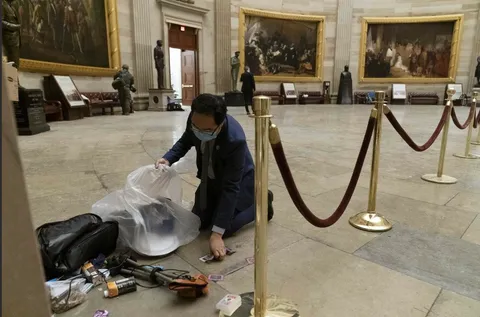Rep. Andy Kim of New Jersey cleaning up the aftermath of the breach of the U.S. Capitol on Wednesday