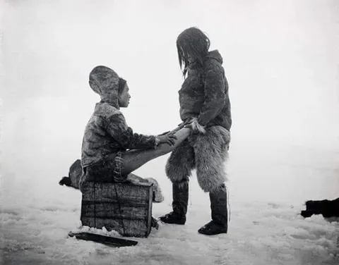 “An Inuit man warming his wife's feet sometime in the 1880s, Greenland.”