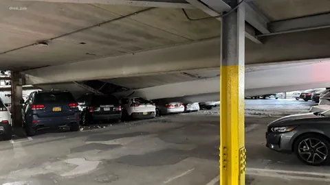 Cars crushed by partial parking garage collapse in White Plains, NY.