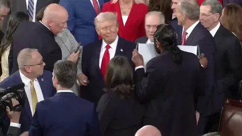 Rep. Al Green holding up a sign that said "Black people are not apes” before Steve Scalise pulled it down