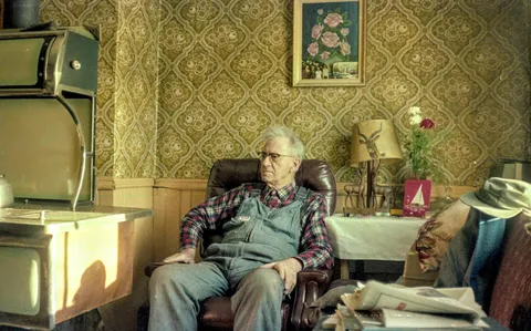 My grandfather in his recliner next to the old wood stove. 1980. He was 86.