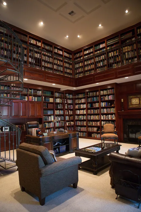 Double-height home office library with a fire place [660x990]