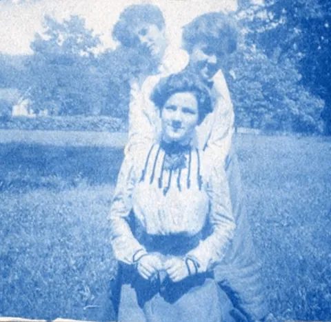 An unnamed young woman recorded her senior year at Asheville Female College in a photo album, Asheville, North Carolina, 1902. It includes a dorm room, group shots of friends, playing in snow, a visit to the mountains, their final midnight party before graduation, and graduation day itself.