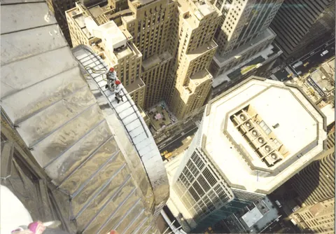 Checking the steel spire of the Chrysler Building for water leaks, New York
