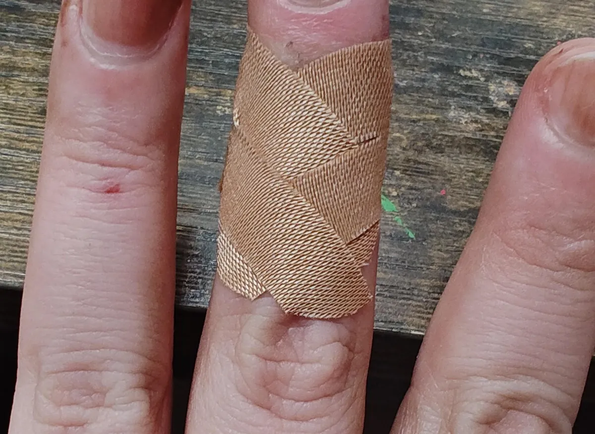 Bandaid kept falling off. Cut the wings down the middle and cross-crossed them and now it stays on all day