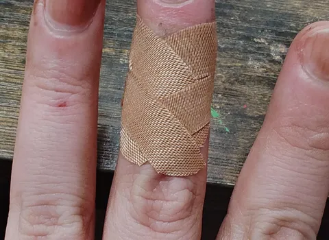 Bandaid kept falling off. Cut the wings down the middle and cross-crossed them and now it stays on all day