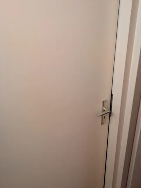 Bedroom door blocked from the inside with a fallen coffee table - what can i try?