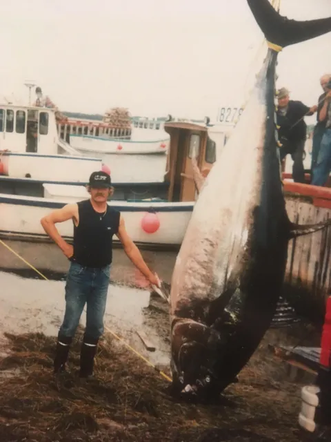 A year ago I posted a picture of my father on his fishing boat that you enjoyed. For the anniversary, I present my father, 1987, with one of his prized catches.