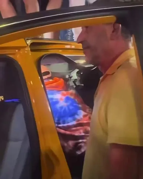 Guy's face as Knicks fans celebeate by jumping on his cab, breaking his only source of income