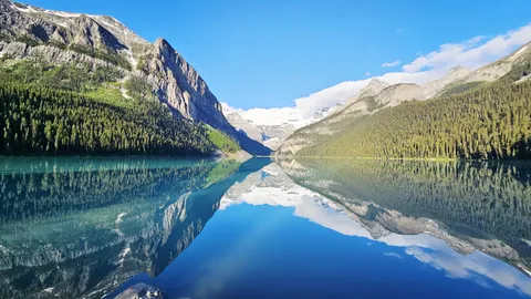 A mirror-smooth morning at Lake Louise, Alberta [4000x2252] [OC]