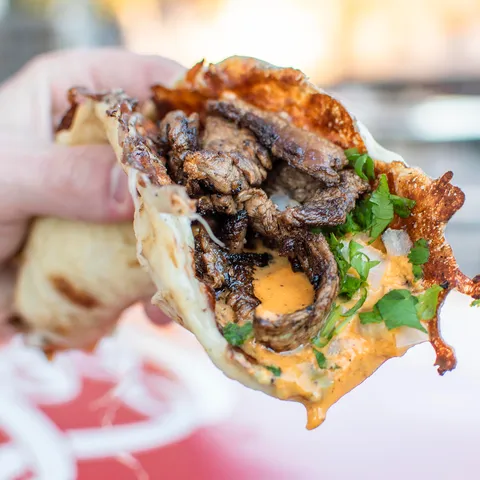 [I Ate] “Quesadilla de Carne Asada” - pan-seared Oaxacan cheese and brined strip loin steak garnished with cilantro, onion, roasted salsa roja, fresh avocado cream, and lime.