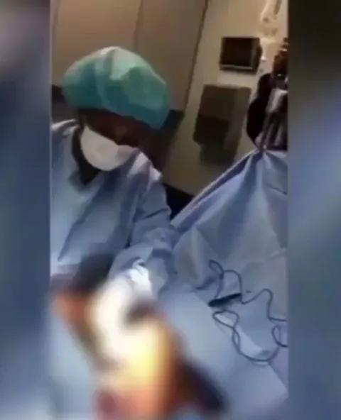 Surgeon and staff dancing and rapping while operating on patients