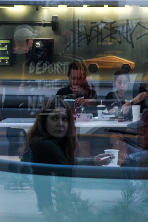 The Tesla Diner in Hollywood threw a Halloween party tonight… so the protesters outside did too [OC]