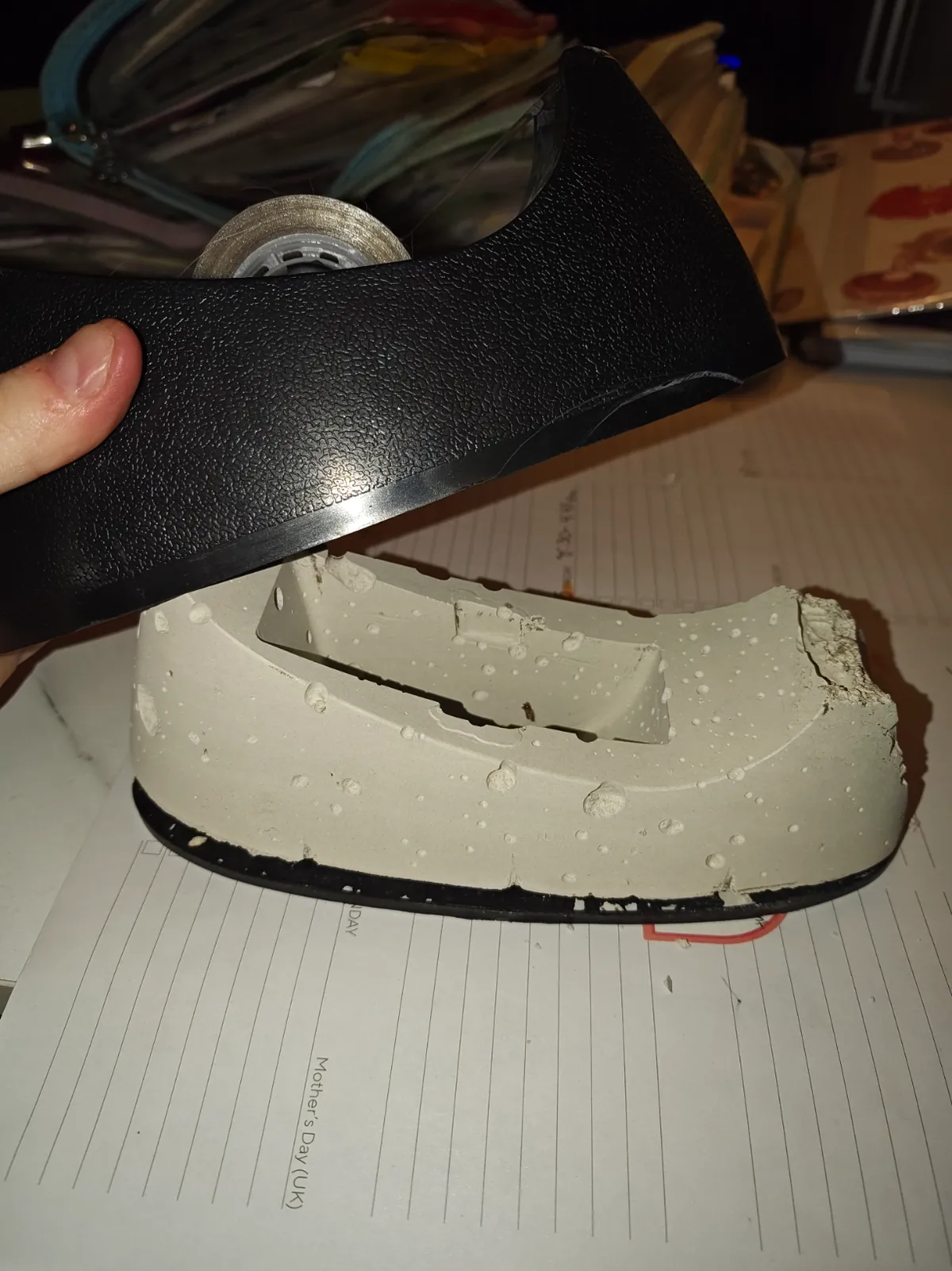 Tape dispenser broke open to reveal plaster that looks like cheese
