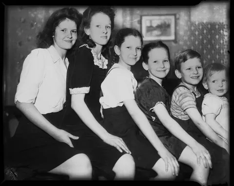 Group of siblings posing for their photo sit by age, circa 1944.