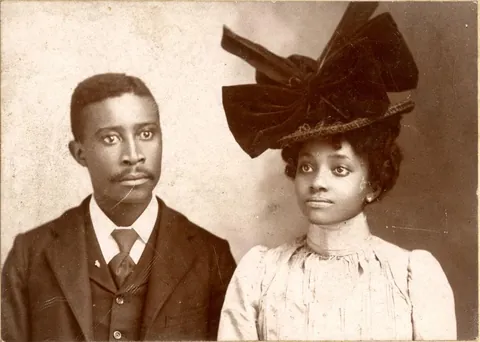 Young couple posing for their portrait together, circa 1890s.