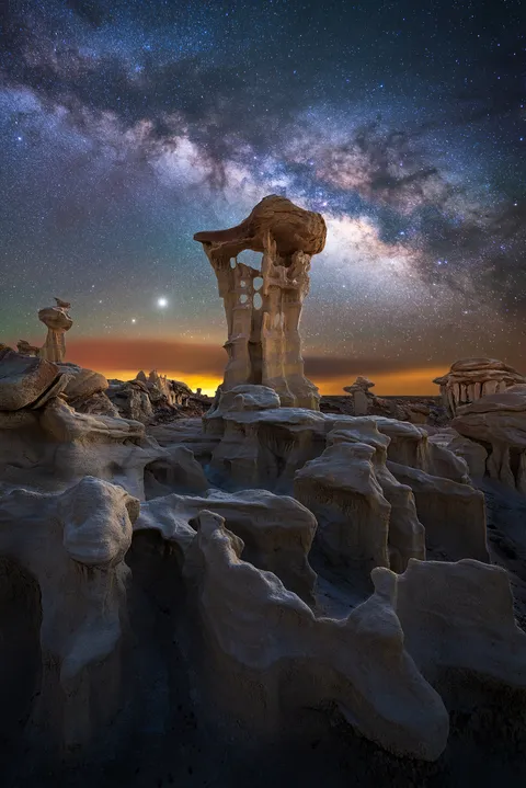 Milky Way, Jupiter and Saturn over otherworldly rock formations in New Mexico